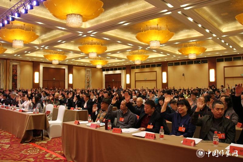 在中国作家协会第九次全国代表大会第三次全体会议上，代表们举手表决。